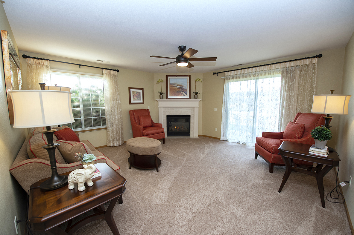 a living room with a couch and chairs and a fireplace