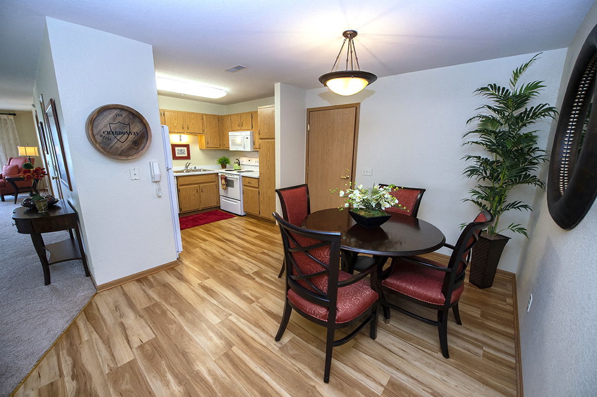 a dining room with a table and chairs and a kitchen