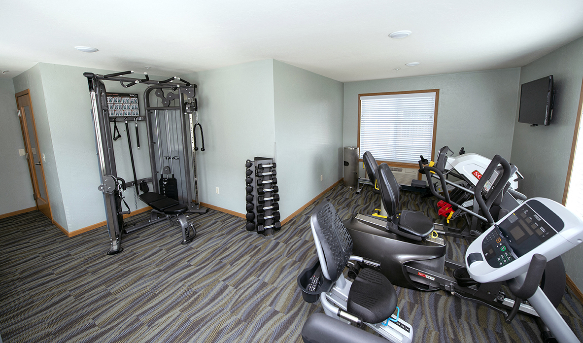 a home gym with exercise equipment and a window