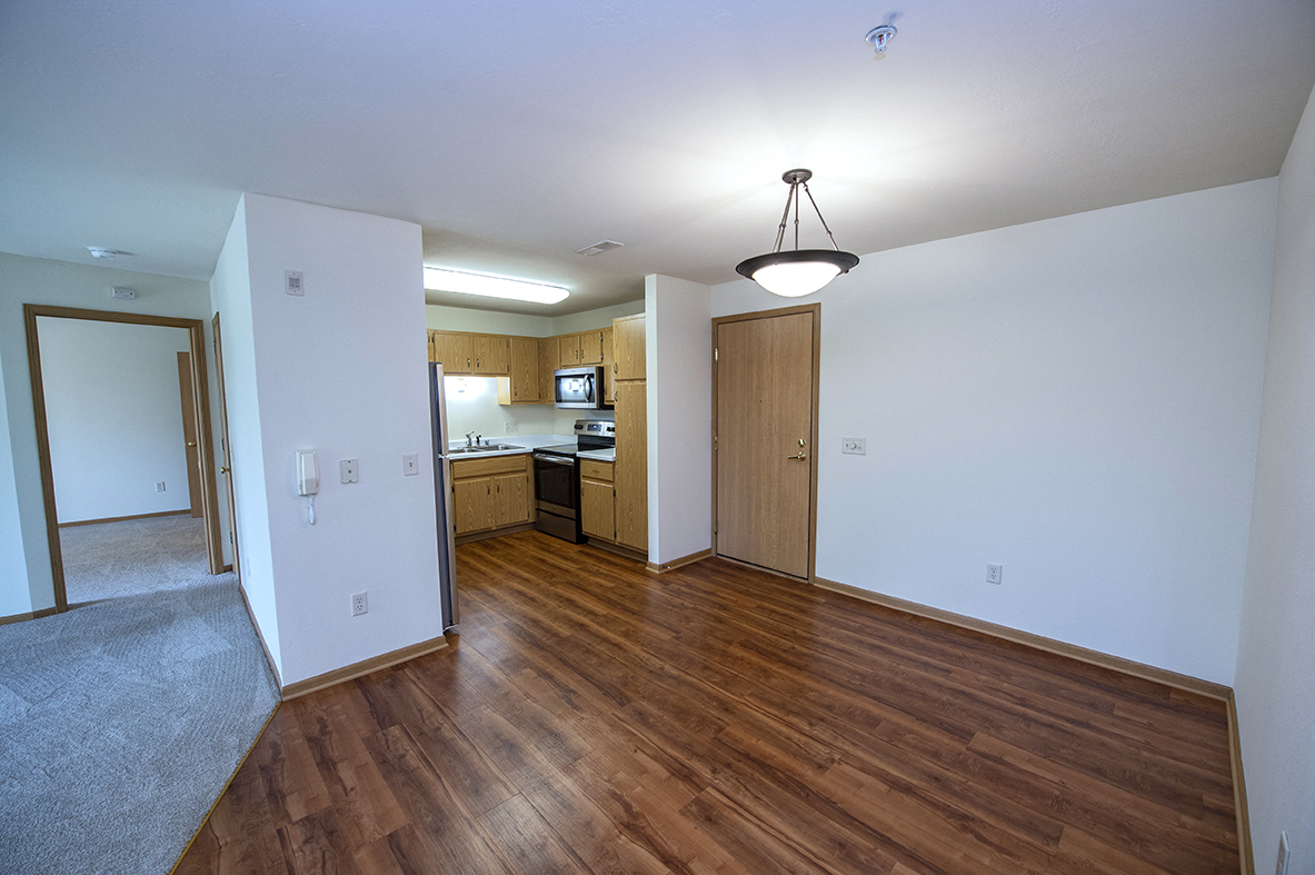 an empty living room and kitchen of an apartment