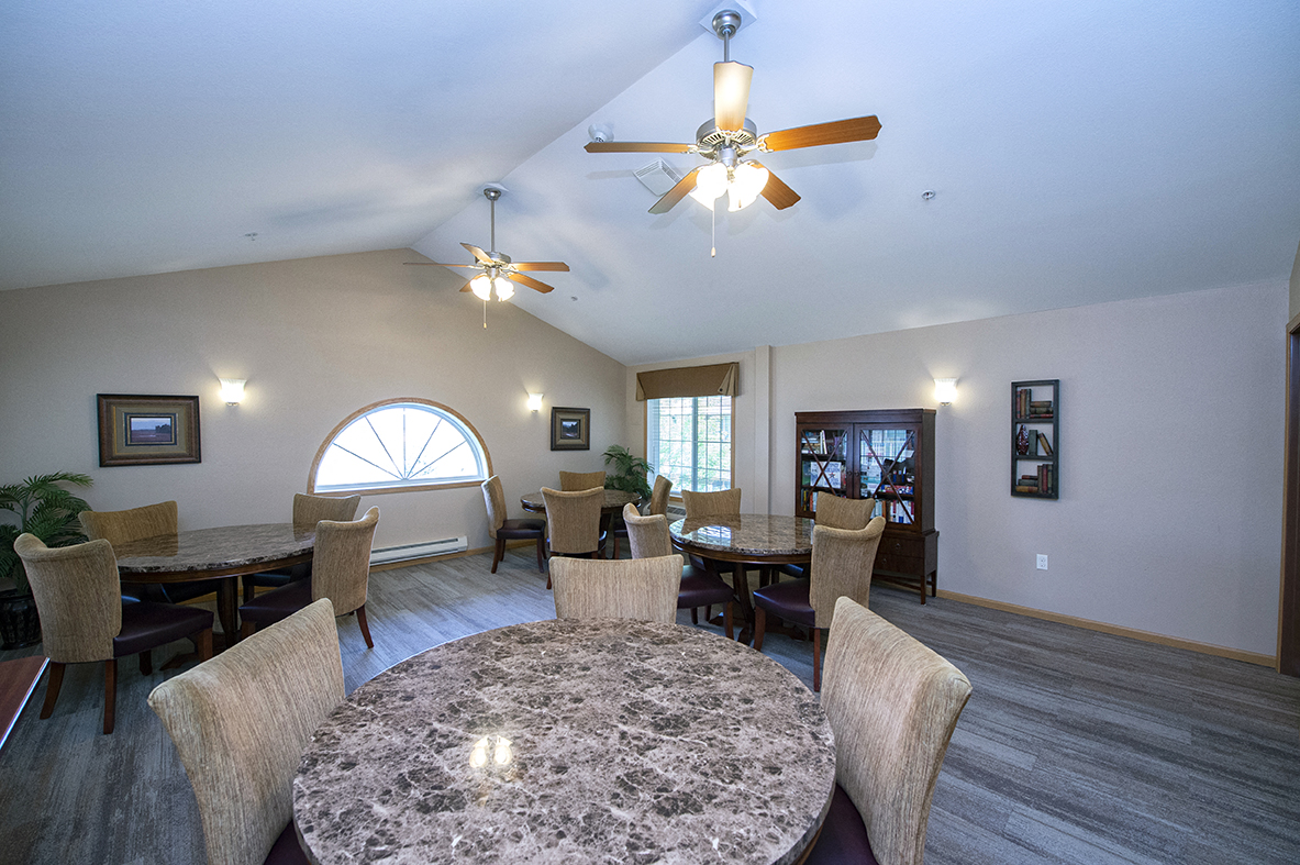 a dining room with a table and chairs and a ceiling fan