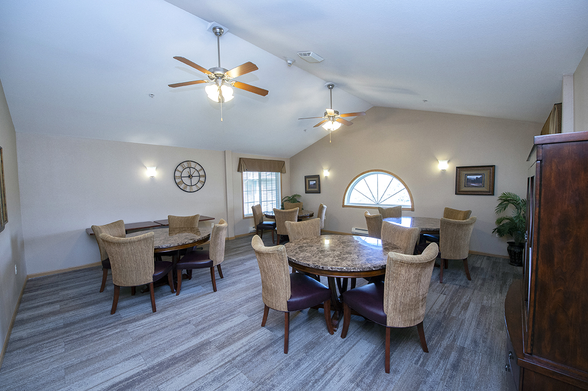 a dining room with a large table and chairs and a ceiling fan