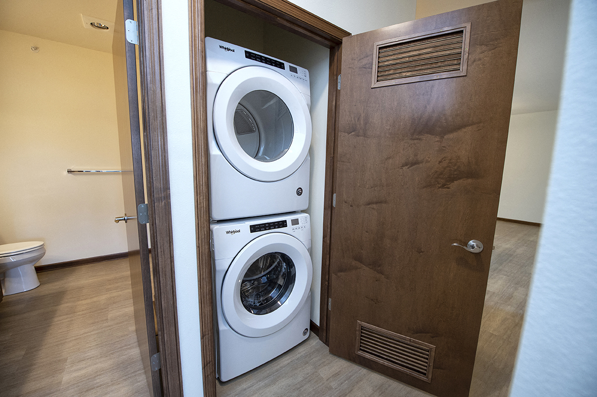 a small bathroom with a washing machine and a dryer