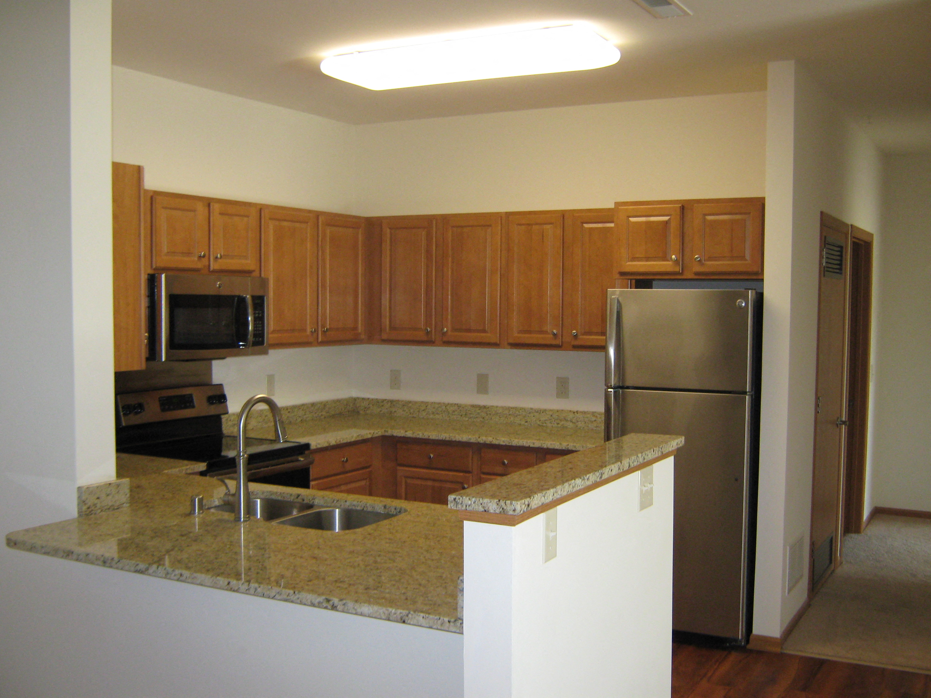 Gourmet Kitchens with Islands, Caesarstone Countertops, and Decorative Backsplash at Foresthill Highlands Apartments & Townhomes 55+, 8930 West Highland Park Avenue, Wisconsin
