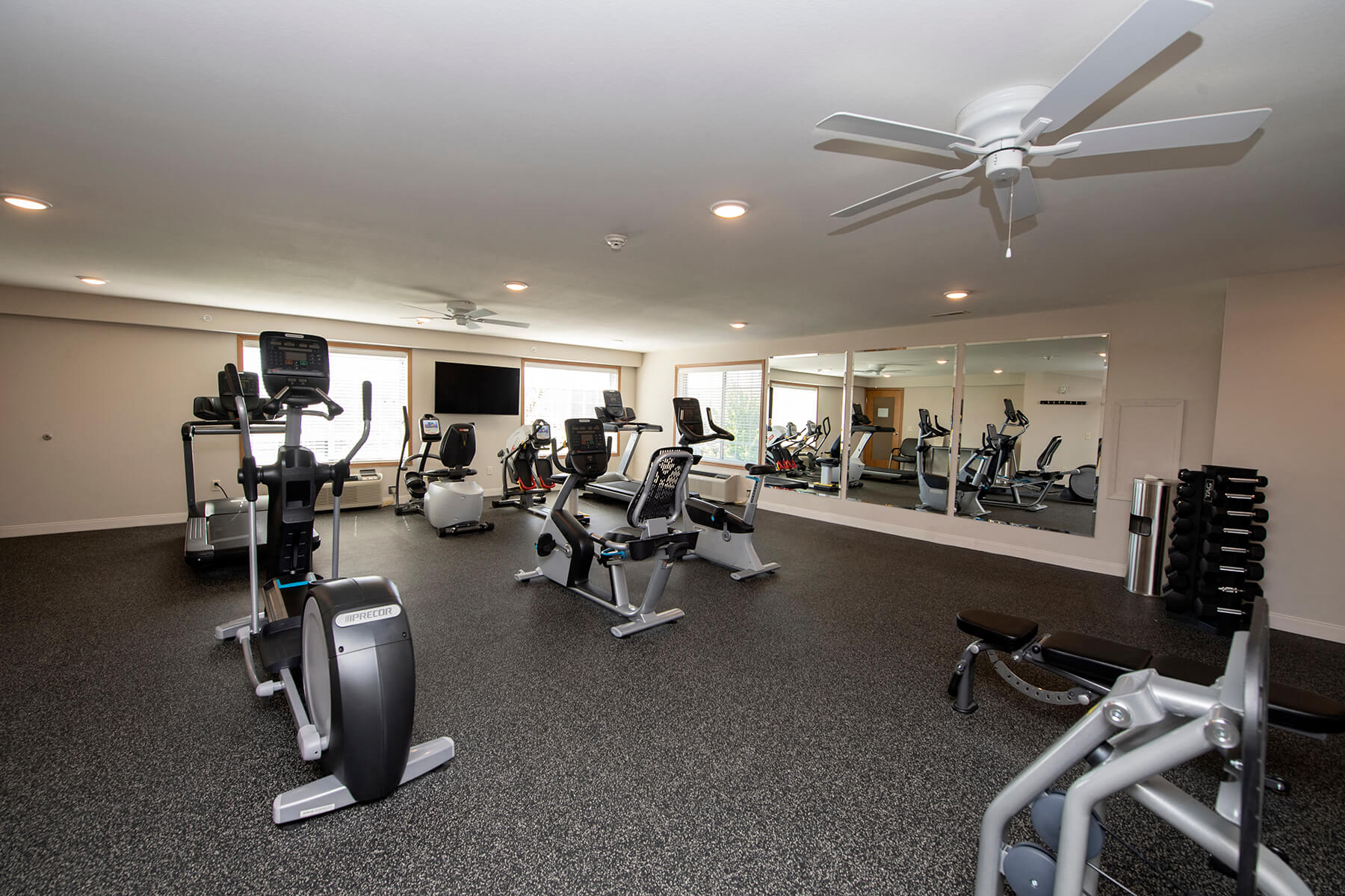 a gym with treadmills and other exercise equipment