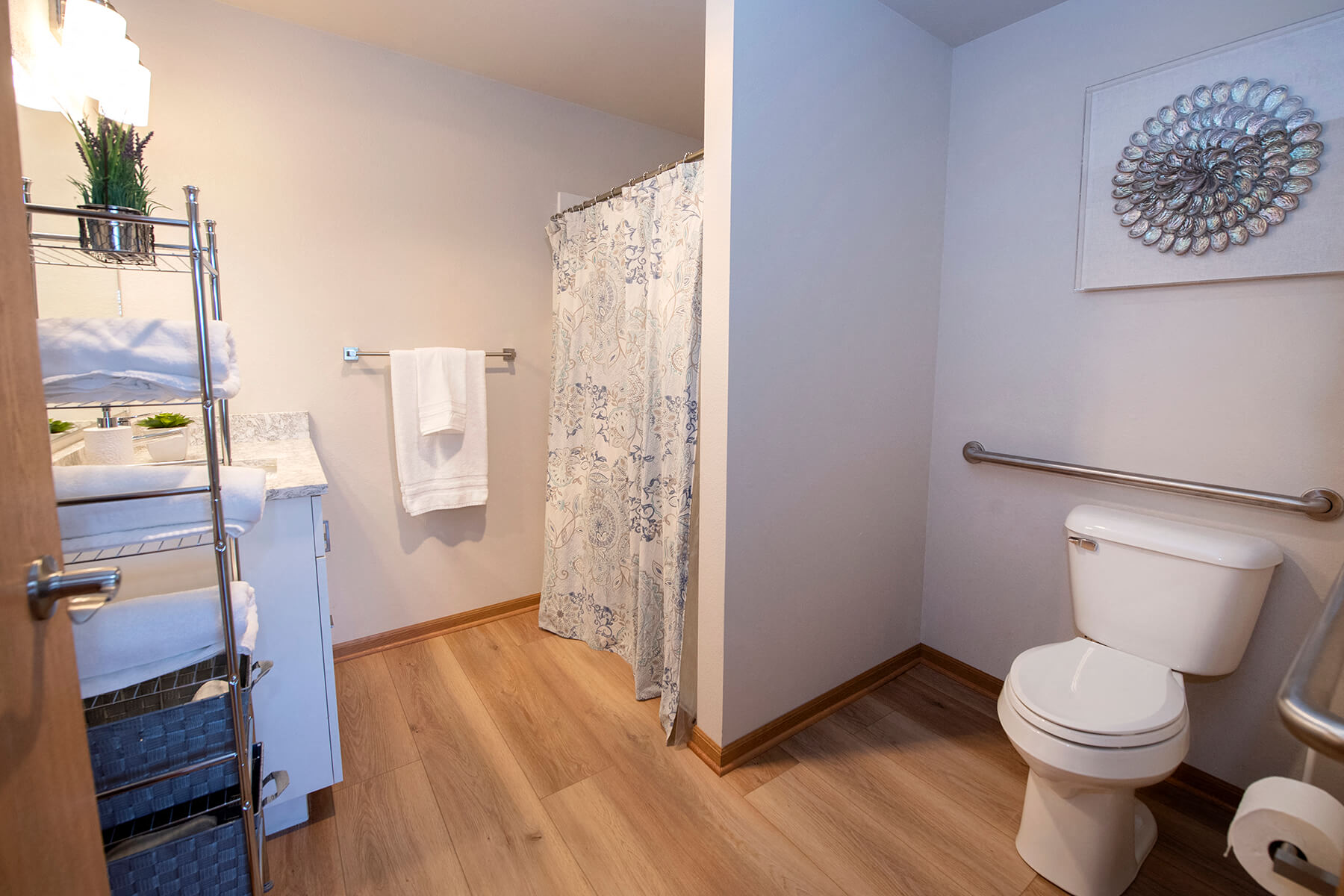 a bathroom with a toilet and a shower and a sink