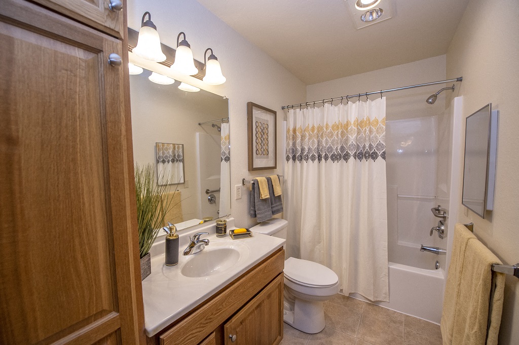 a bathroom with a shower and a sink and a toilet