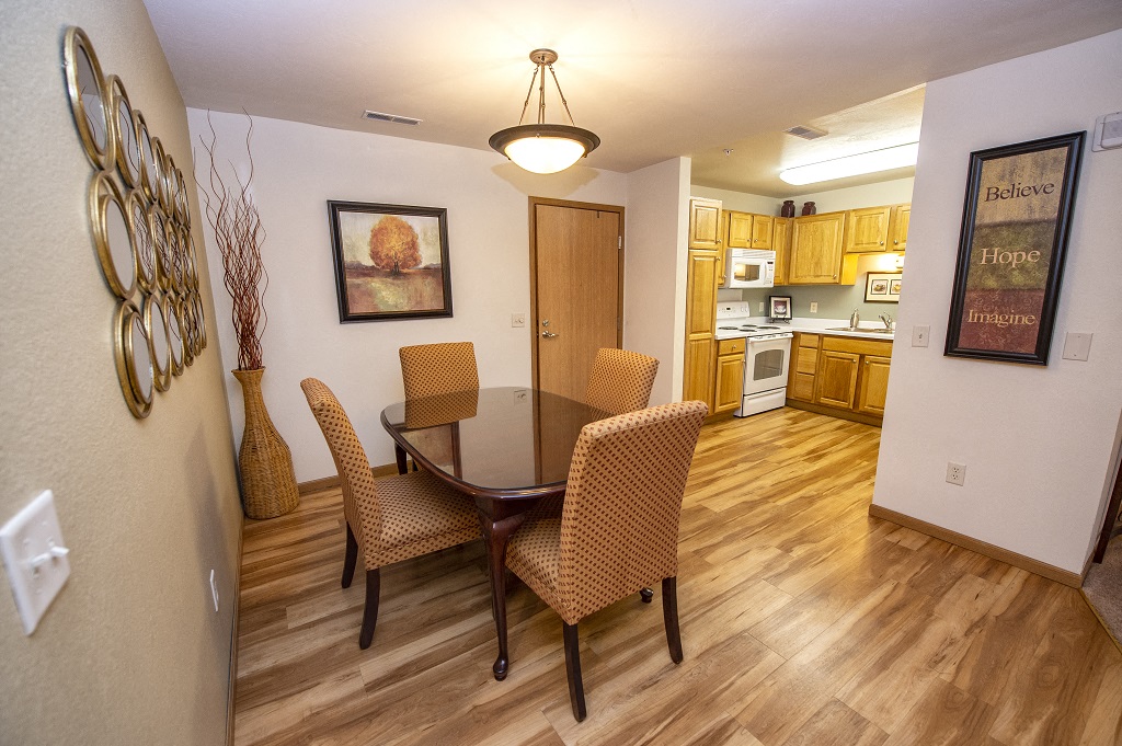 a dining room with a table and chairs and a kitchen