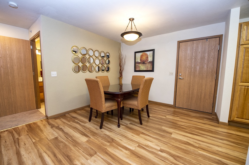 a dining room with wooden floors and a table and chairs