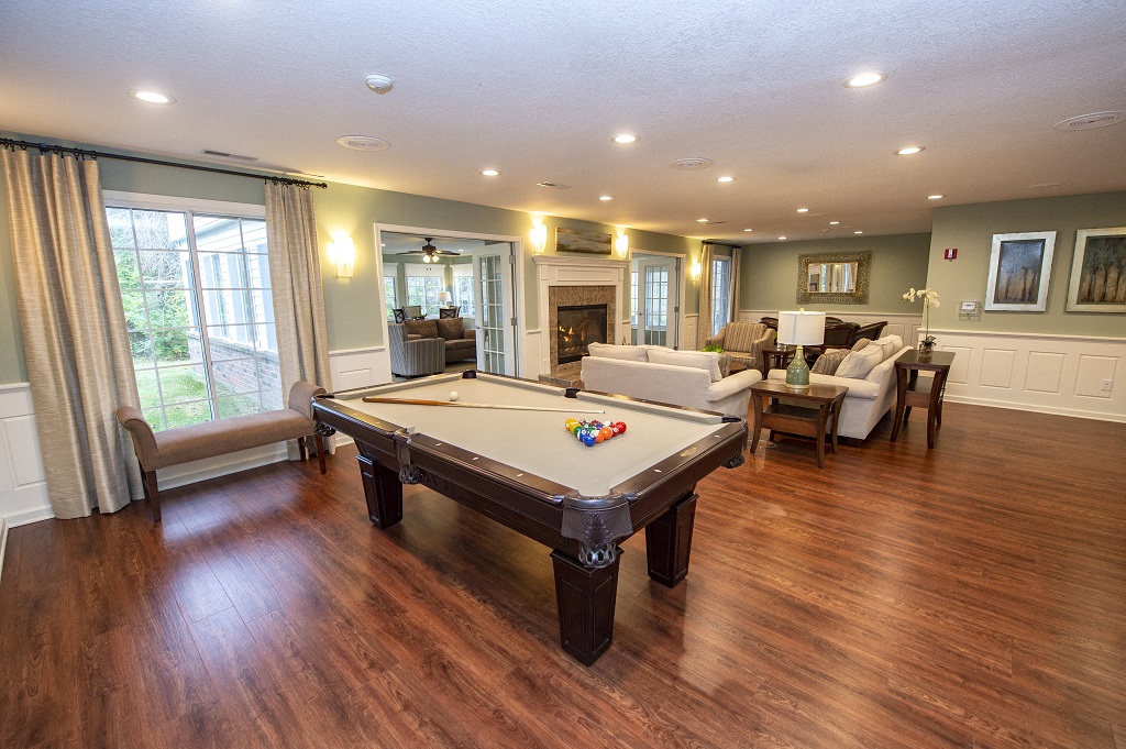 a pool table in the center of a living room