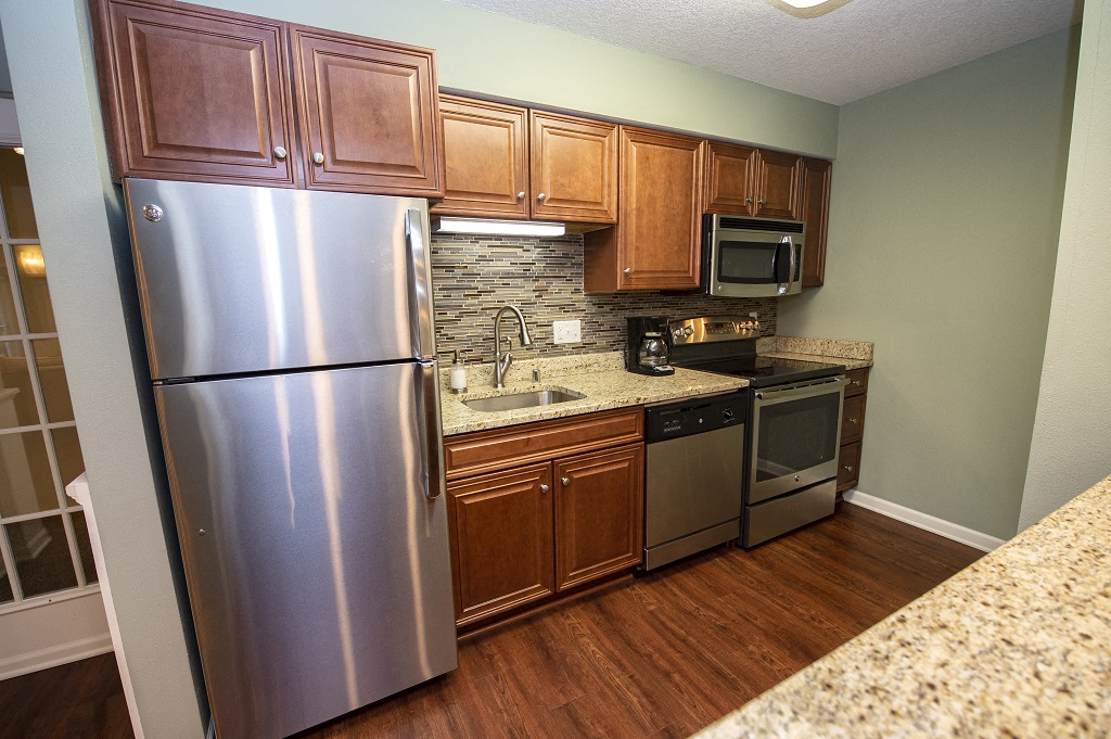 a kitchen with stainless steel appliances and wooden cabinets