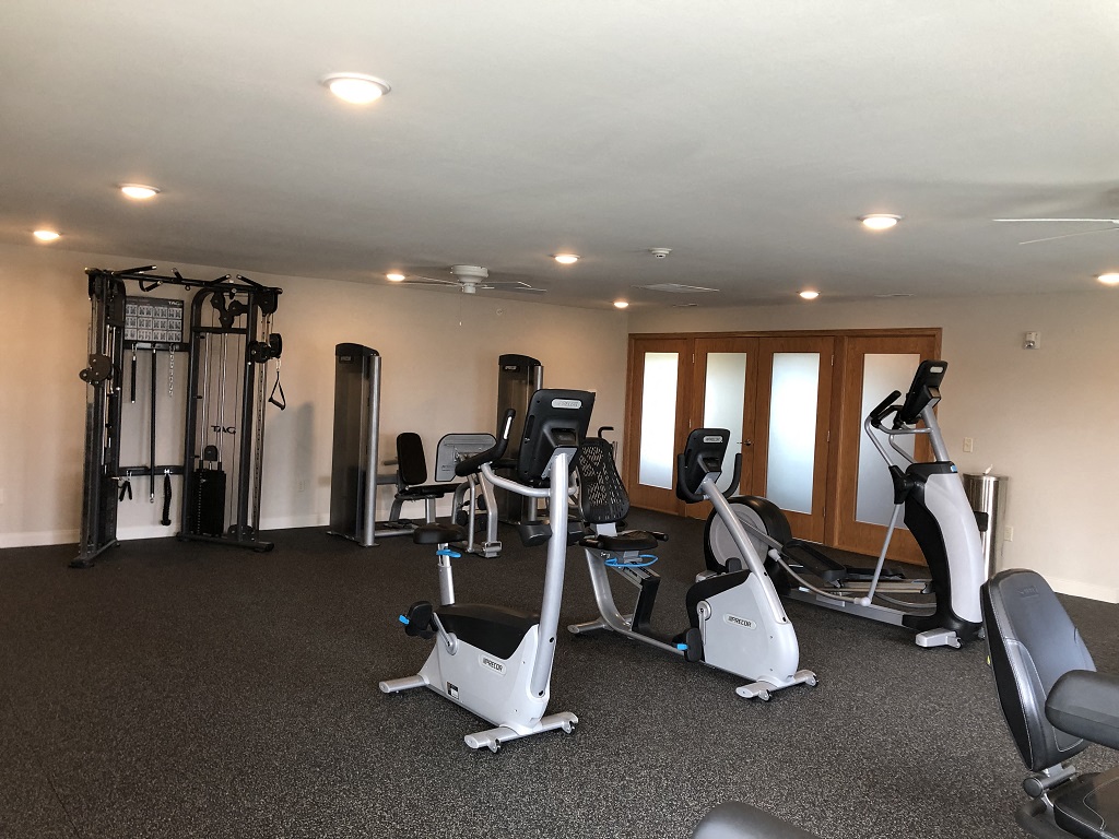 a gym with treadmills and other exercise equipment