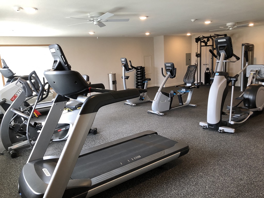 a gym with various treadmills and other exercise equipment
