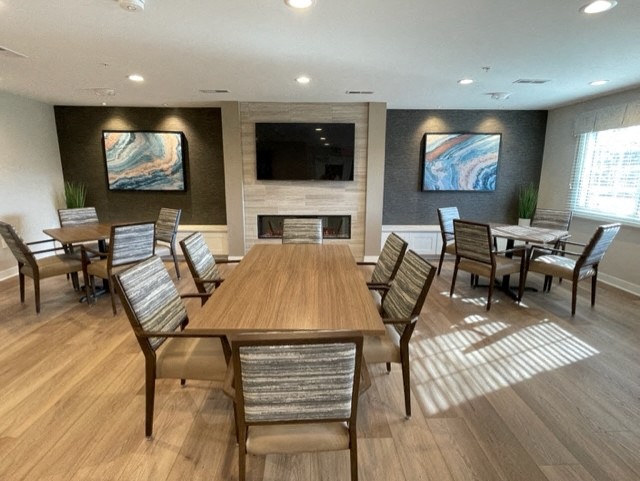 a conference room with a large table and chairs and a television