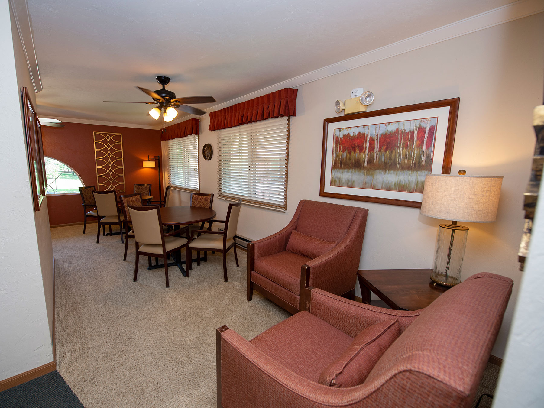 a living room with couches and chairs and a dining room table
