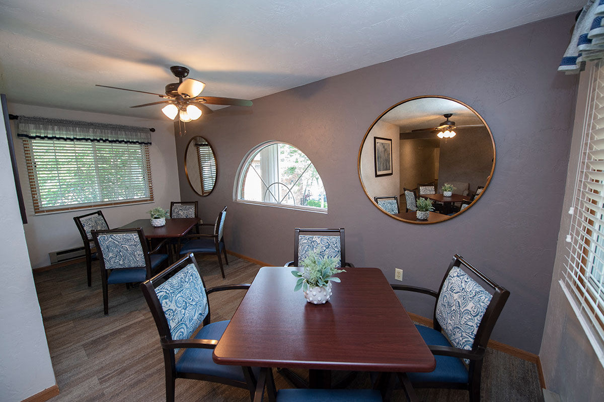 a dining room with a wooden table and chairs