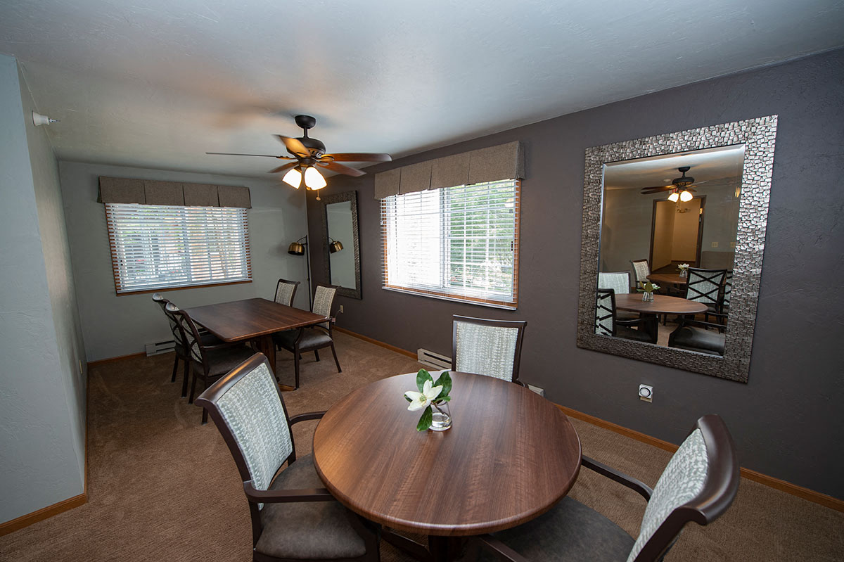 a dining room with a table and a ceiling fan
