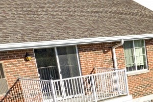 Exteriors-Outdoor Patio an aerial view of a large brick house with patio furniture and a lawn