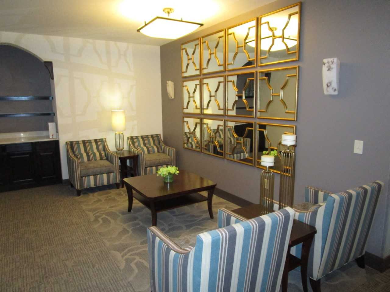 a living room with chairs and a table