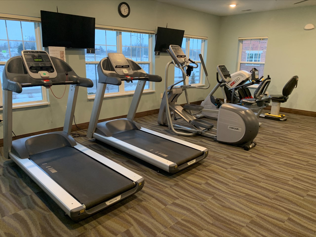a gym with treadmills and exercise equipment at the at the village