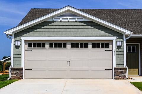 A two-car garage with a stone pillar on the left side.