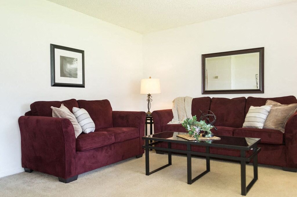 a living room with two couches and a table