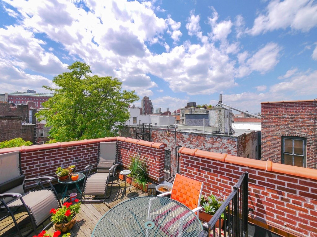 the roof deck has a view of the city and the sky