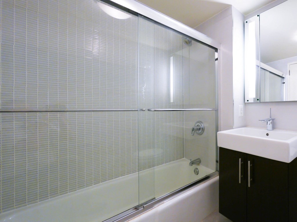 a bathroom with a shower and a sink