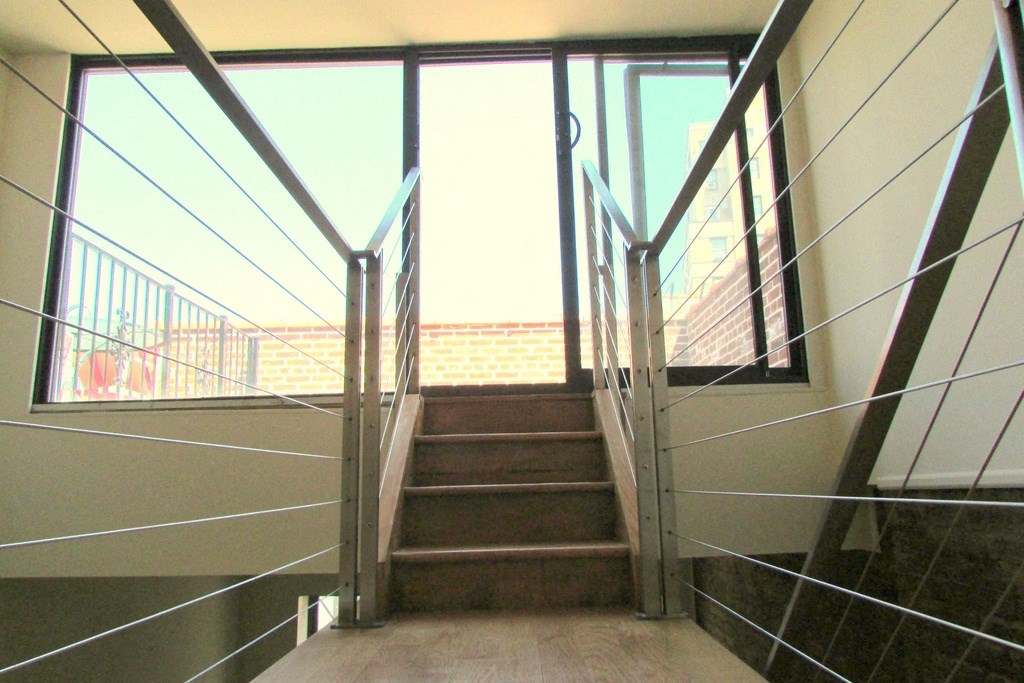 a set of stairs with glass doors and steel railings