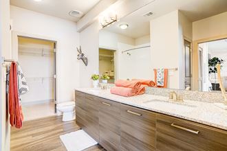 a bathroom with a large mirror and a sink