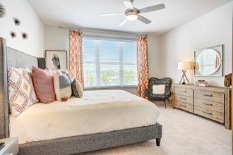 a bedroom with a bed and a ceiling fan