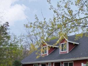 a red house with a yard and trees
