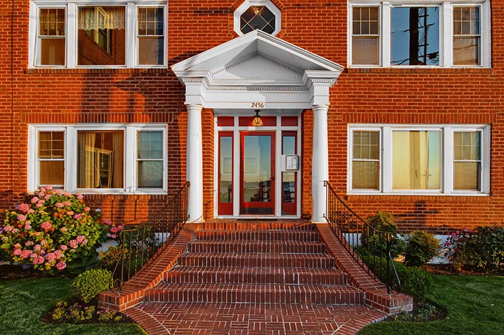 a red brick house with a red front door