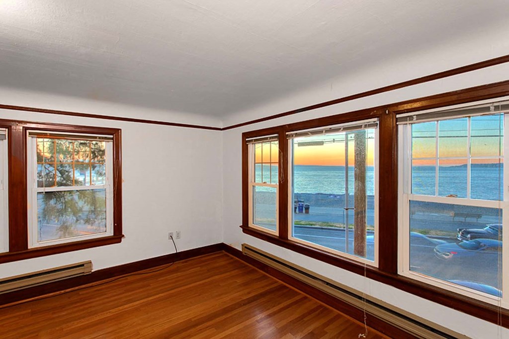 a living room with a view of the beach and the ocean