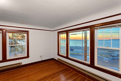 a living room with a view of the beach and the ocean
