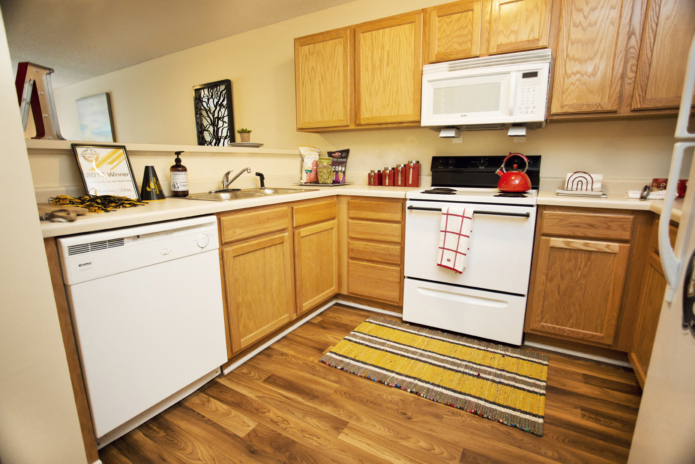 a kitchen with white appliances and wooden cabinets