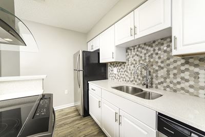 Kitchen With White Cabinetry And Appliances at Lincoln Pointe, Florida