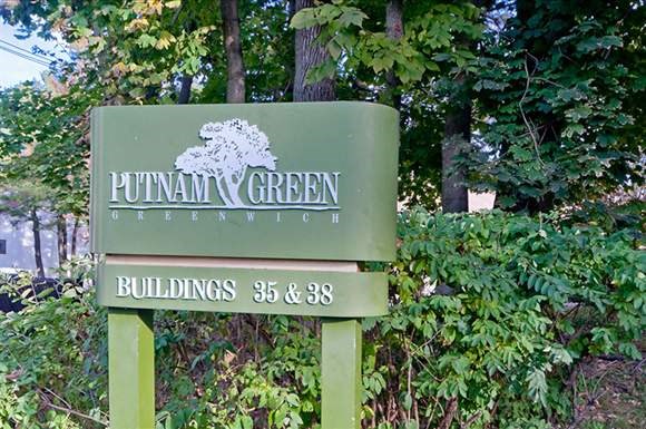 a green sign for the puma green buildings 35  89