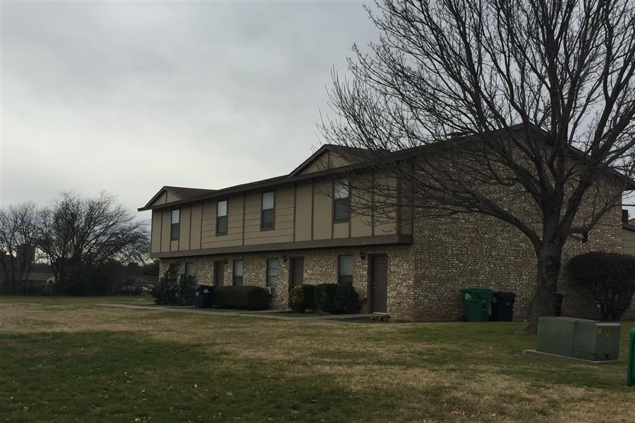 a house with a yard and a tree in front of it