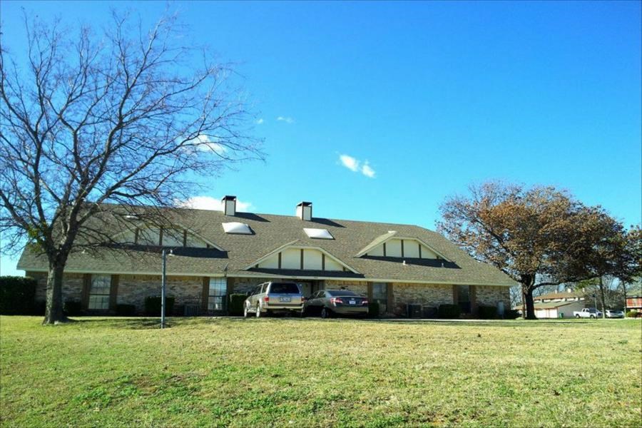 a large house with two cars parked in front of it