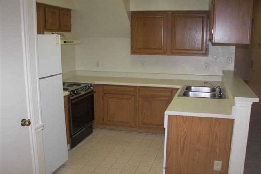 a kitchen with a stove and a sink and a refrigerator