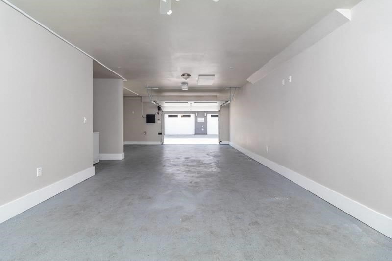 an empty garage with white walls and a concrete floor
