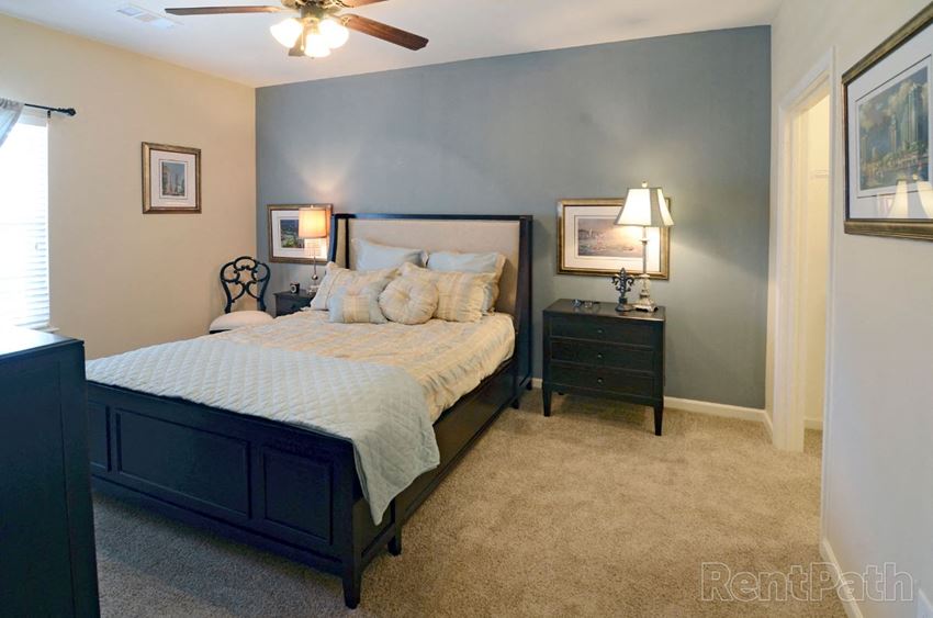 a bedroom with a bed and two night stands