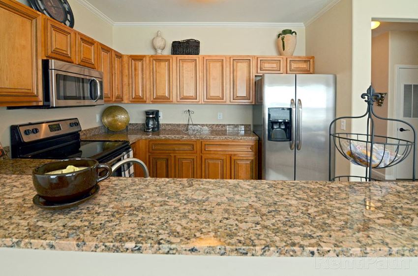 a kitchen with granite counter tops and stainless steel appliances