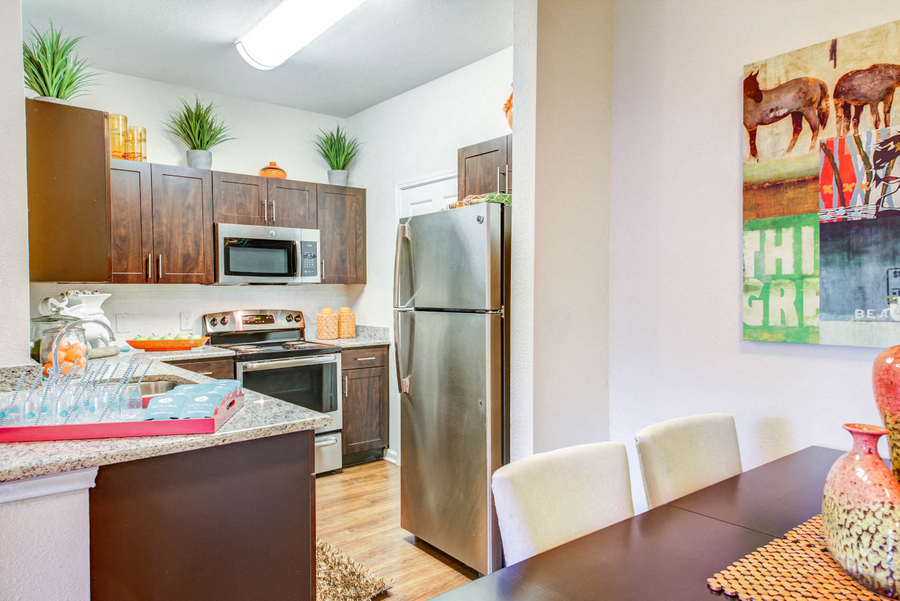 Dinning room looking into kitchen with stainless steal appliances