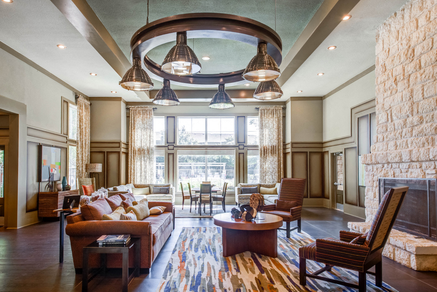 Community lounge with couch seating and a fireplace