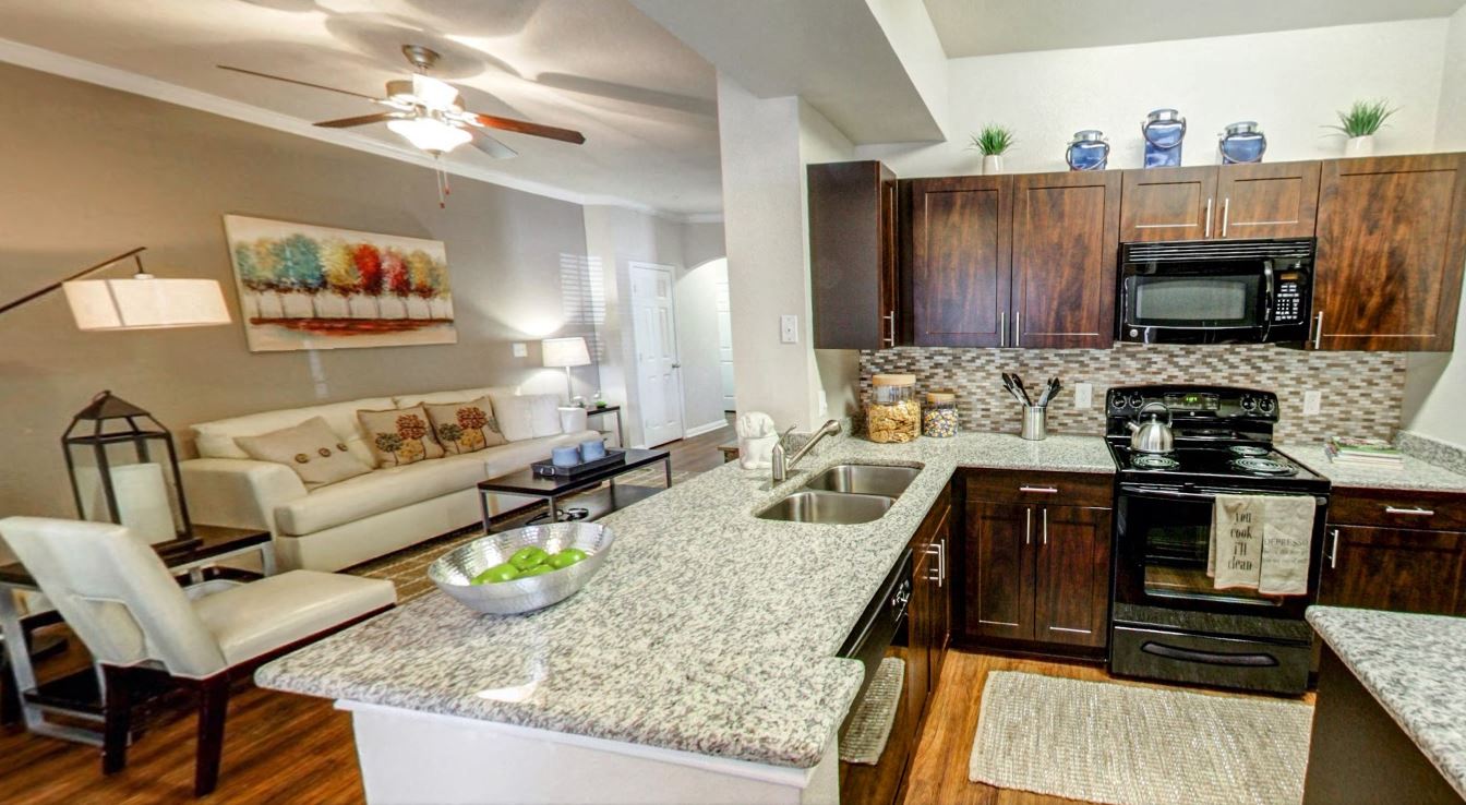 Kitchen with energy efficient appliances and bar overlooking the living room