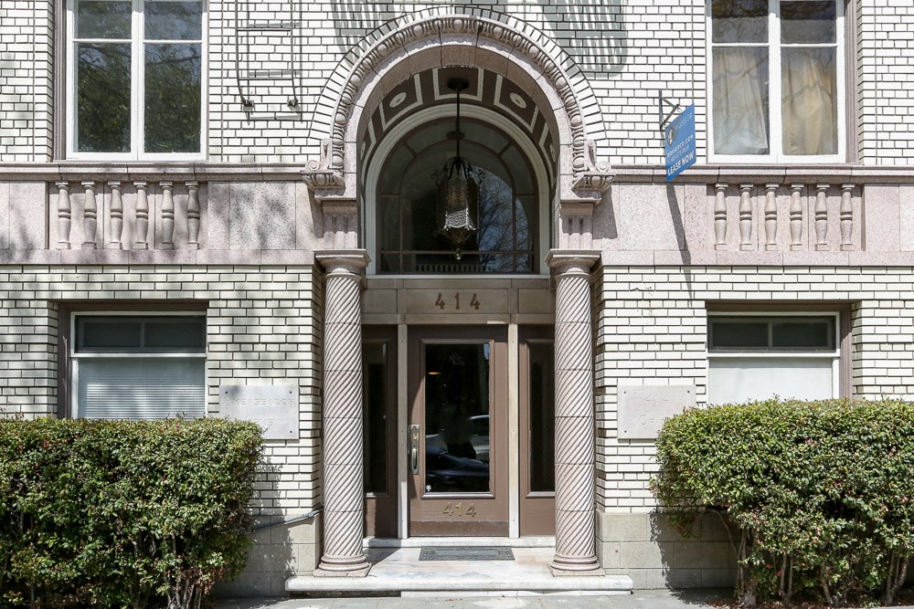 the front of a building with a door and a window