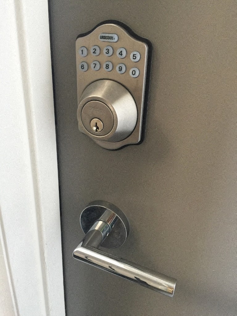 a stainless steel door handle with a key lock