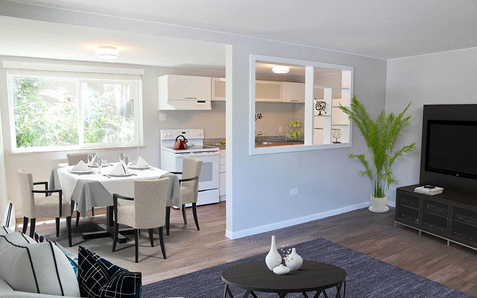 a living room and kitchen with a table and chairs